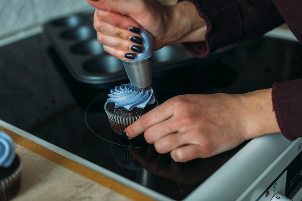 crop-hands-decorating-cupcake